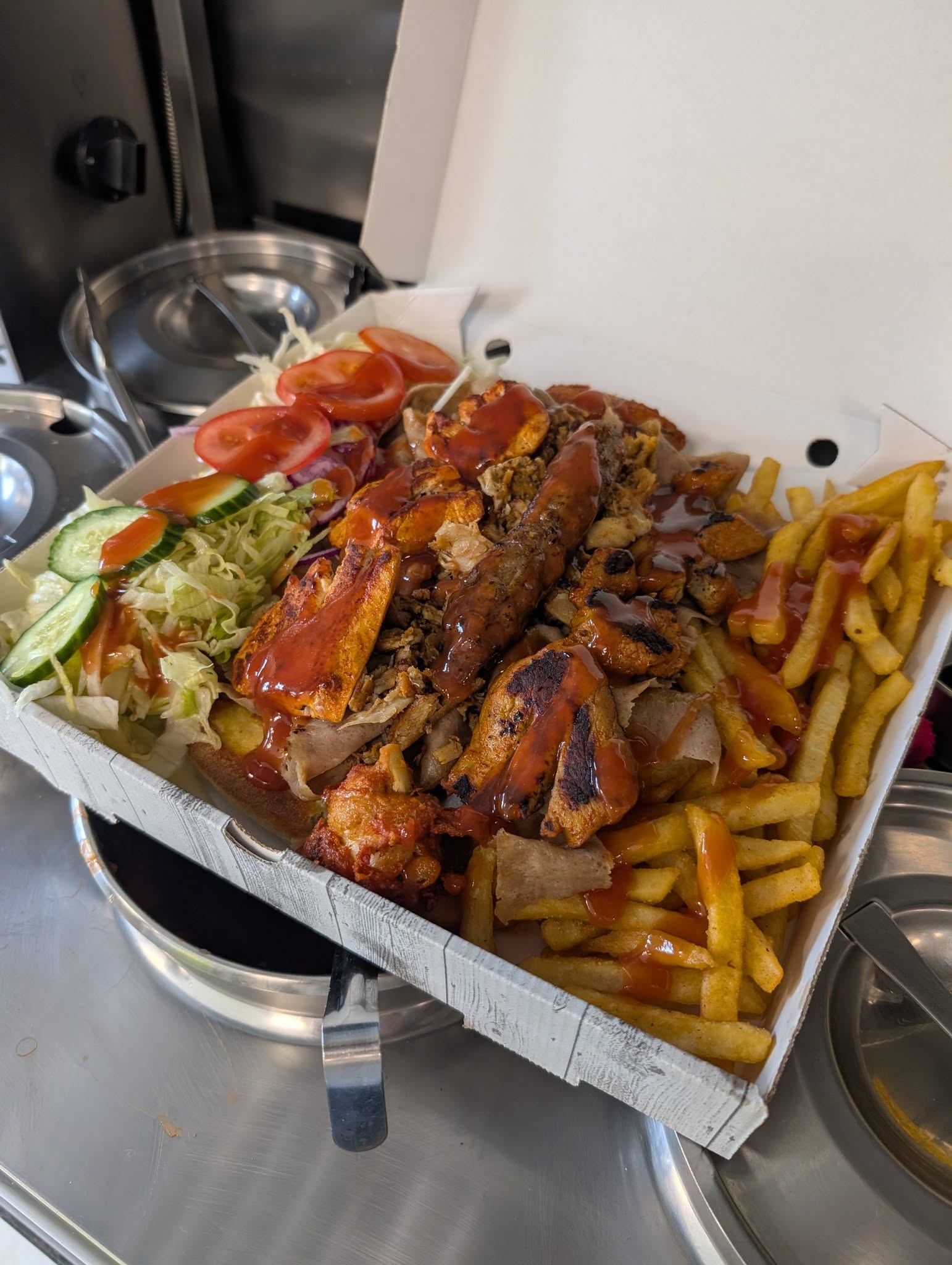 Fully loaded share box with doner, ribs, chicken and fries drenched in BBQ sauce