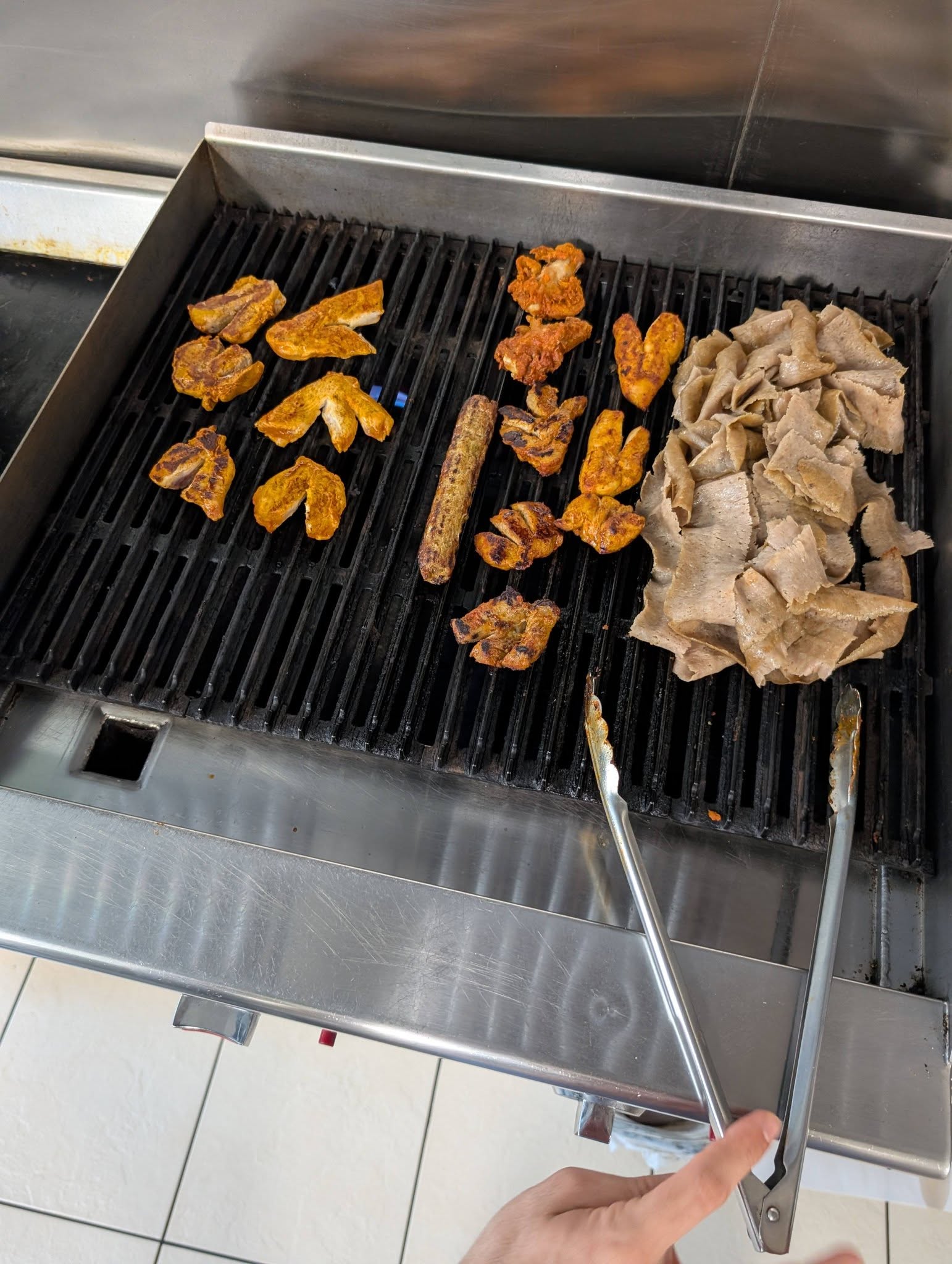 Chicken and doner meat sizzling fresh on the grill